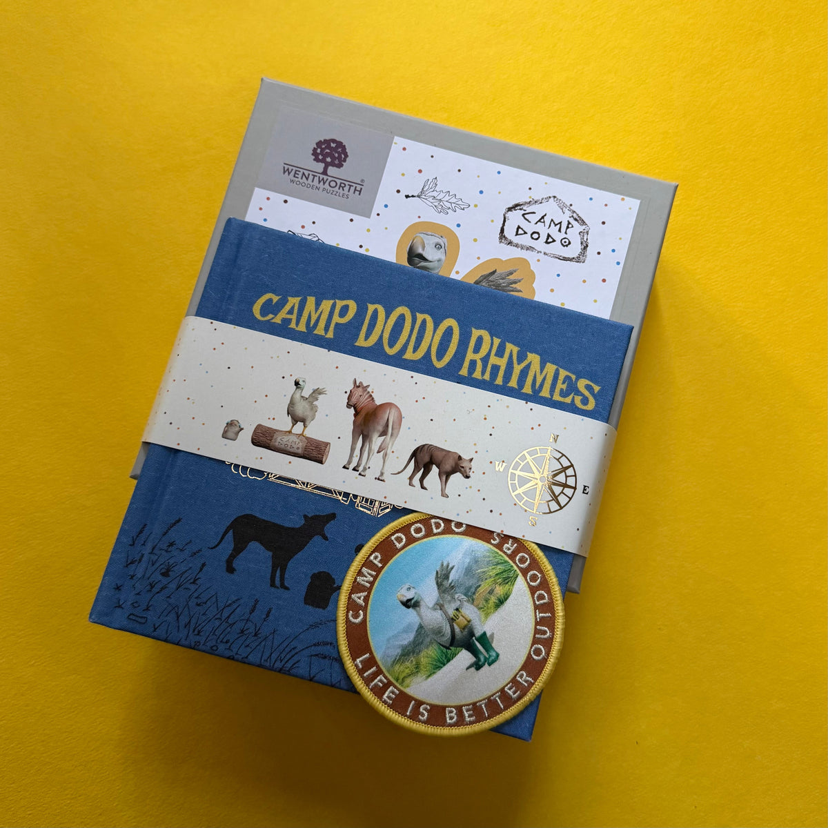 A children's rhyme book titled "Camp Dodo Rhymes", together with high quality Wentworth wooden puzzle.  The set also comes with a special iron-on badge that reads "Camp Dodo Rhymes" and "Life is Better Outdoors.